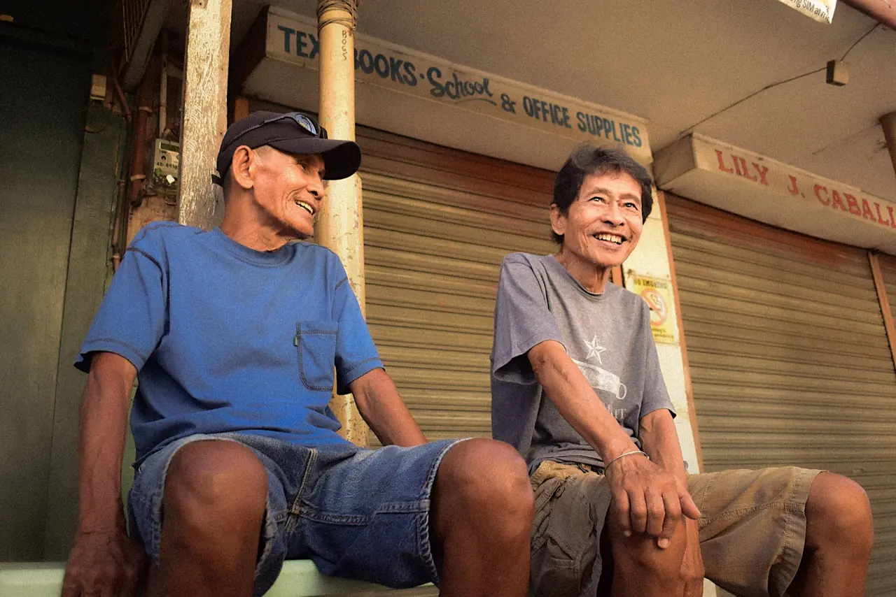 Two friends outside a school supplies shop in Manila